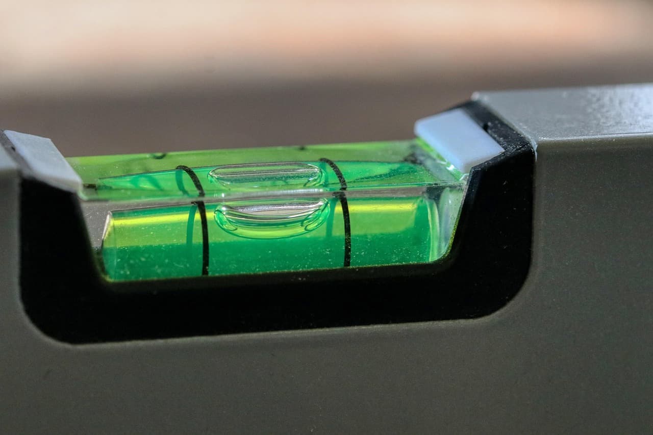 The green bubble vial of an aluminium spirit level, centred between its lines
