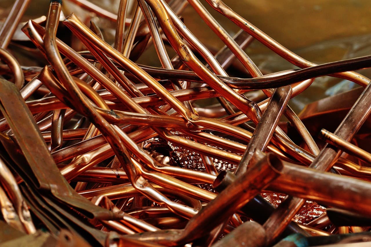 Offcuts of copper pipe and bends in a pile
